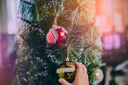 Close-up view of little child hands holding elegant Christmas decorationの写真素材