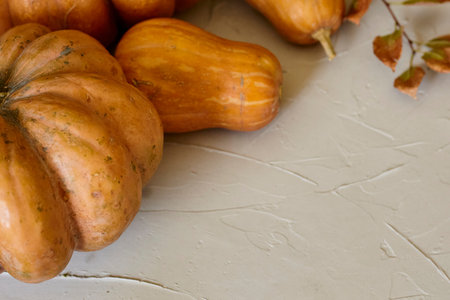 A group of different size autumn pumpkins with fall leaves