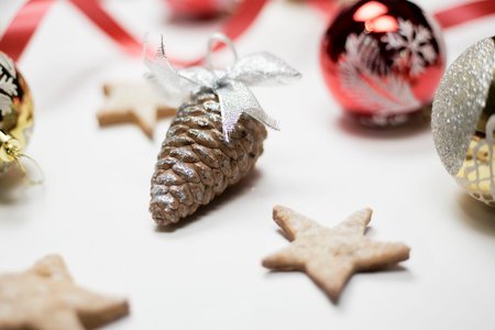 Festive background with Christmas ornaments. Randomly placed Xmas tree toys and pine conesの写真素材
