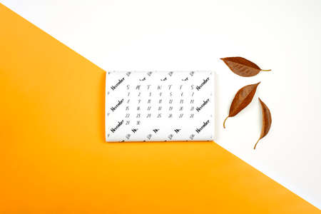 Monthly November calendar on bright colorful background. November paper calendarの写真素材