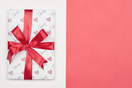 Valentines day background. Bright gift box with heart-shaped paper cut on bright colorful background. Valentines day concept. Copy spaceの写真素材
