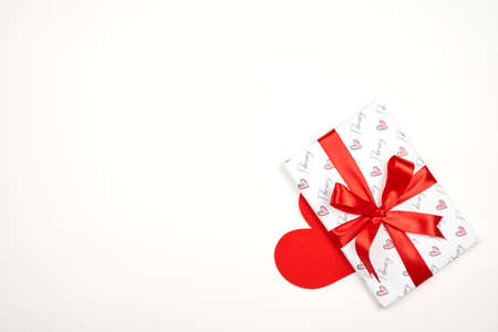 Valentines day background. Bright gift box with heart-shaped paper cut on bright colorful background. Valentines day concept. Copy spaceの写真素材