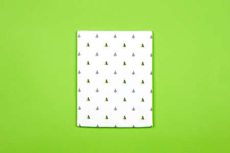 Xmas present wrapped in paper with festive prints. Christmas gift on white background. Homemade bright Christmas present boxの写真素材