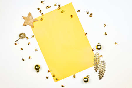 Empty paper decorated with Christmas decorations, star shape cookies and pine cones. Xmas decorations with blank paper on white backgroundの写真素材