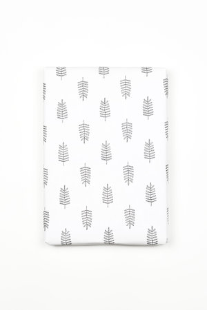 Xmas present wrapped in paper with festive prints. Christmas gift on white background. Homemade...