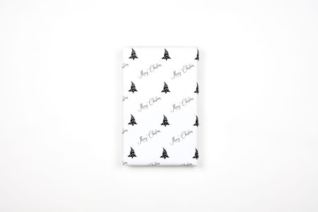 Xmas present wrapped in paper with festive prints. Christmas gift on white background. Homemade...