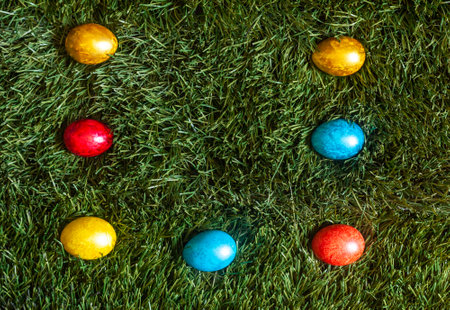 Colorful Easter eggs on the grass. Decorated easter eggs on placed on green grassの写真素材