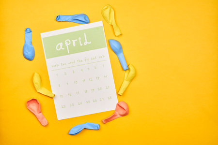 April calendar with copy space on yellow backgroundの写真素材