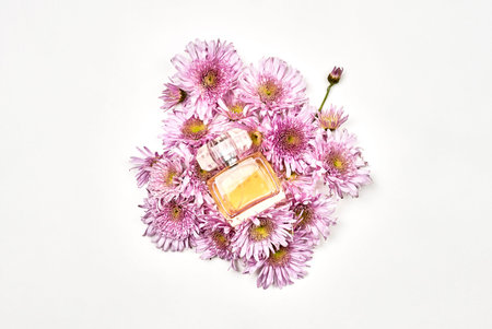 Luxury bottle of aromatic perfume with flowers on white background