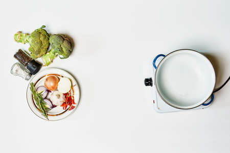 Cooking healthy food with broccoli on portable electric stoveの写真素材