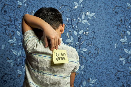 Uch bin dumm, Translation from German language - Im stupid. April fools day jokes. A kid back with stickers and funny jokesの写真素材