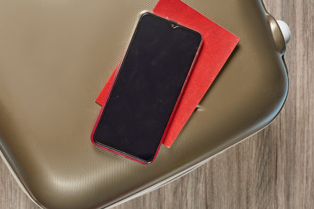 Travel luggage,  passport and mobile phone. Travel with digital  immunity ID. Safe travel concept