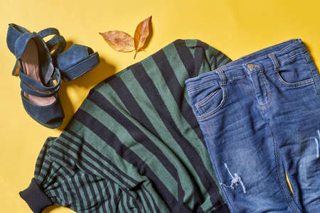 Female autumnal clothes set on yellow background. Set of women outfit clothes on yellowの写真素材