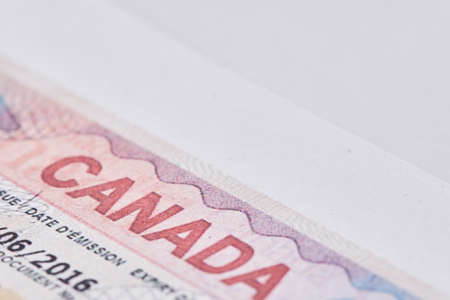 Tashkent, Uzbekistan - 13 August, 2021: Macro shot of Canadian visa. Close-up Canada resident immigration visa in passportのeditorial素材