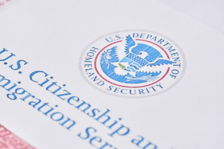Tashkent, Uzbekistan - 13 August, 2021: United States Citizenship and Immigration Services. Envelopes with letter from USCIS on United States flag from Department of Homeland Securityのeditorial素材