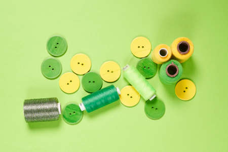 Sewing items from above. Flat lay composition with sewing accessories on light color background. Items for sewing, Sewing clothes, measuring tape, tailoring scissors, threads, buttons and needlesの写真素材