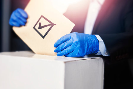 A person in medical gloves voting. Election concept. Presidential or Parliament election. A voter...