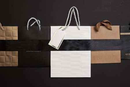 Black friday concept. Pile of various shopping bags on black background.の写真素材