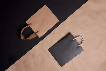 Black friday concept. Shopping bags on split black and craft background.の写真素材