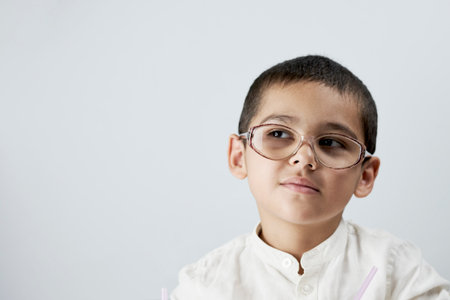 Smart boy in glasses against the white backgroundの写真素材