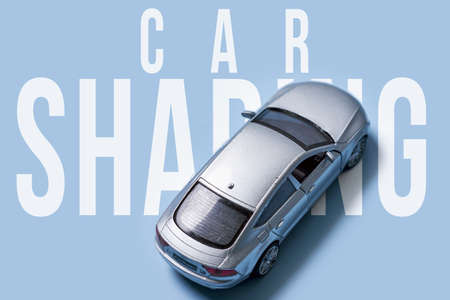 Car sharing concept with gray car toy on blue backgroundの写真素材