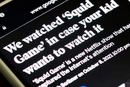 Tashkent, Uzbekistan - 14 October 2021: Reading breaking news about Popular Netflix new show - Squid games. World press about new South Korean series show - Squid gamesのeditorial素材