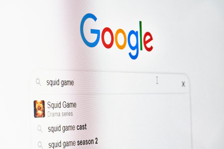 Tashkent, Uzbekistan - 14 October 2021: Searching information on Google about Popular Netflix show - Squid games. Searching about release date of new season 2 of South Korean series show - Squid gamesのeditorial素材