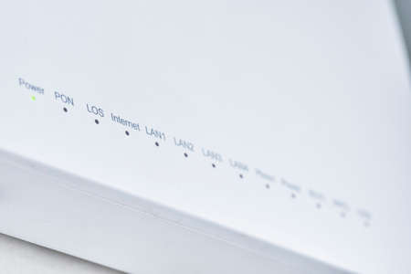 Close-up view of Internet wifi router device. Icons on the WiFi router indicating the signal and connection. modem router. Fast internet modem deviceの写真素材