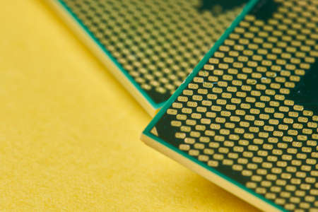 Macro-shot of computer microchip processor. Global chip and semiconductor shortage. Symbol of ongoing crisis in car industry. Concept of high demand for integrated circuitsの写真素材