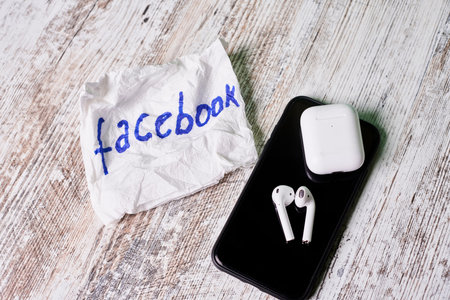 Tashkent, Uzbekistan - 22 October, 2021: Facebook logo on napkin and mobile phone with portable...