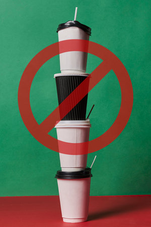 Stop using single-use plastic. A pile of plastic coffee cups with forbidden sign.の写真素材