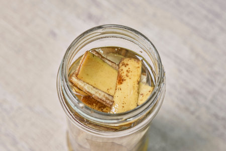 A jar filled with banana peel cuts and water. Banana peel for plant fertilization. Eco friendly...