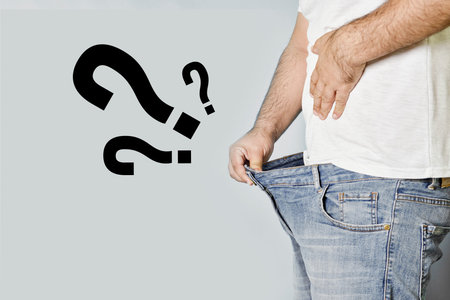 A man with erectile dysfunction looking into his jeans waiting for any reaction. Concept of mens...