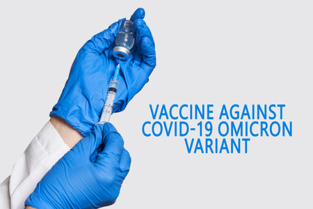 A doctor holds vaccine against new covid-19 omicron variant. New generation vaccine against Coronavirus South African variant. Omicron variant of SARS-CoV-2. New B.1.1.529 Variant of concernの写真素材