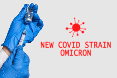 A doctor holds vaccine against new covid-19 omicron variant. New generation vaccine against Coronavirus South African variant. Omicron variant of SARS-CoV-2. New B.1.1.529 Variant of concernの写真素材