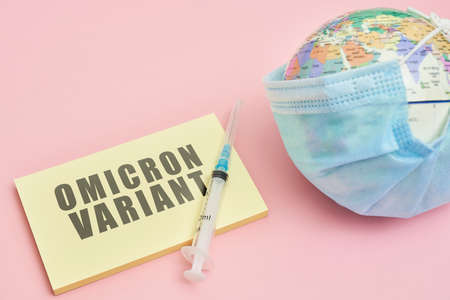 Globe in face mask and syringe. New vaccine against Omicron variant. Symbol of global roll-out new generation of vaccine against Omicron strain of virus. Omicron variant vaccineの写真素材