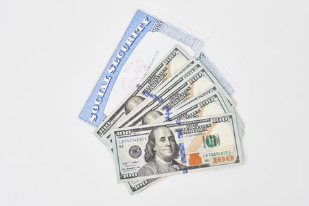 Social security card and us dollars cash money on white. Social security benefits. Concept of social security benefits payment, retirement and federal government benefitsの写真素材