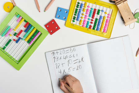 Mental math for adults. Doing math. Cropped shot of a person hands doing arithmetic. Overhead view of a student doing math with manual bead calculator. A boy using bead counter for calculationの写真素材