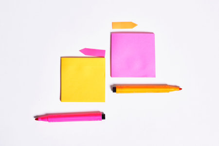 Colored sticky notes and markers with copy space on white background