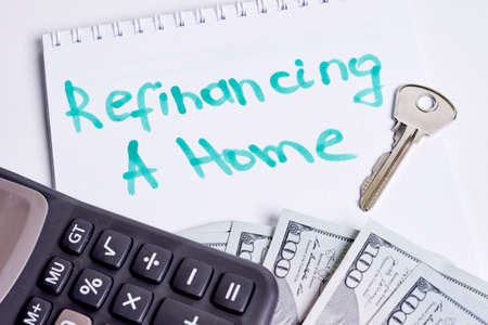 Refinancing a home concept. House keys, calculator and moneyの写真素材