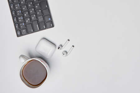 Bright office workspace. Work space with notepad, keyboard, coffee and glasses. Work space table desk. Flat lay, top view, copy spaceの写真素材
