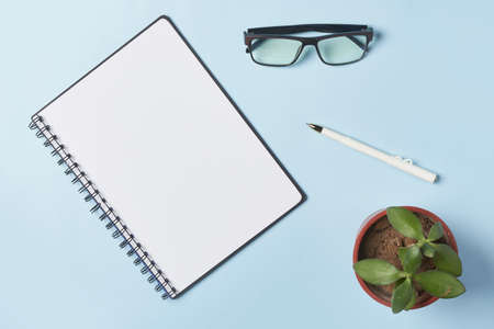Bright office workspace. Work space with notepad, keyboard, coffee and glasses. Work space table desk. Flat lay, top view, copy spaceの写真素材