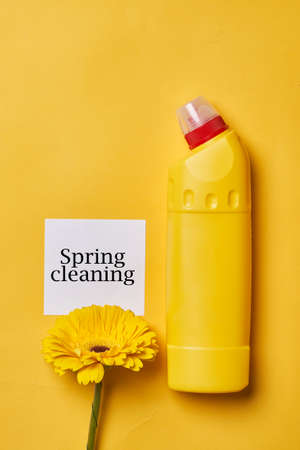 Cleaning service concept. Spring cleaning. Cleaning chemical bottles and supplies. House cleaning concept on colored backgroundの写真素材