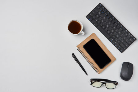 Bright office workspace. Work space with notepad, keyboard, coffee and glasses. Work space table...