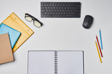 Bright office workspace. Work space with notepad, keyboard, coffee and glasses. Work space table desk. Flat lay, top view, copy spaceの写真素材