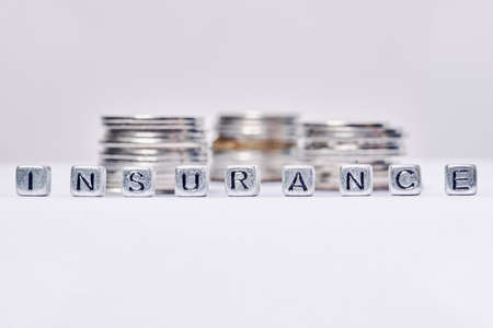 Insurance word made of silver cubes on the white backgroundの写真素材