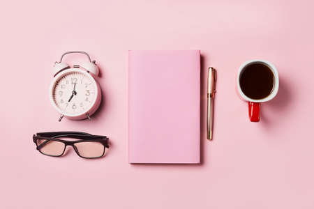 Christmas background with blank notebook surrounded by Christmas decorations. Letter to Santa or Christmas shopping list on pink backgraundの写真素材