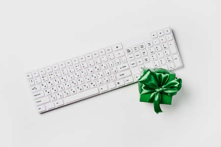 Christmas, desk office with laptop and work supplies with green gift box on white backgraund. Top view with copy space for input the text. Flat lay desk table winter Christmas.の写真素材