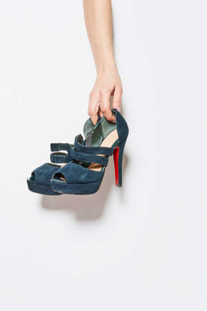 woman holding stylish fashionable leather lace-up shoes. Fashionable collection of womens autumn shoes. Close-up of female legs in shoes.の写真素材