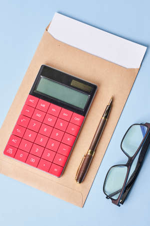 Envelope and financial documents with calculator on blue background. Close upの写真素材